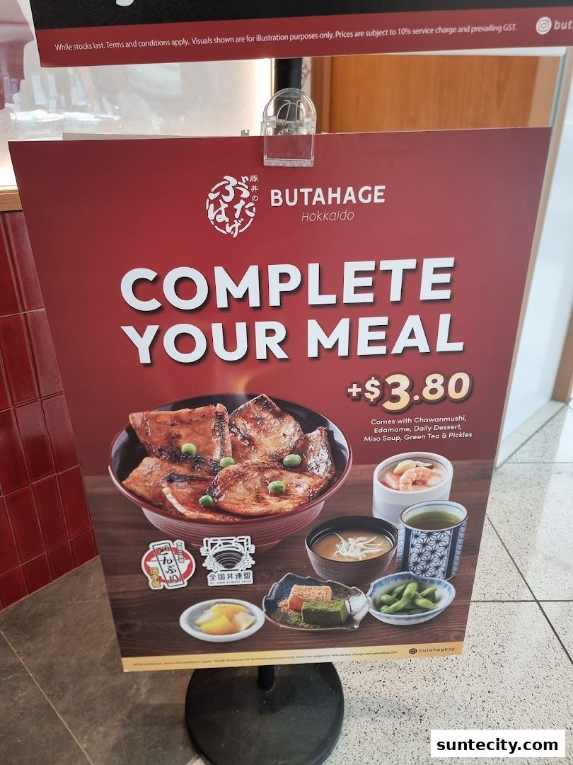 A promotional sign for Butahage Hokkaido, advertising a meal deal with a bowl of meat and various side dishes.