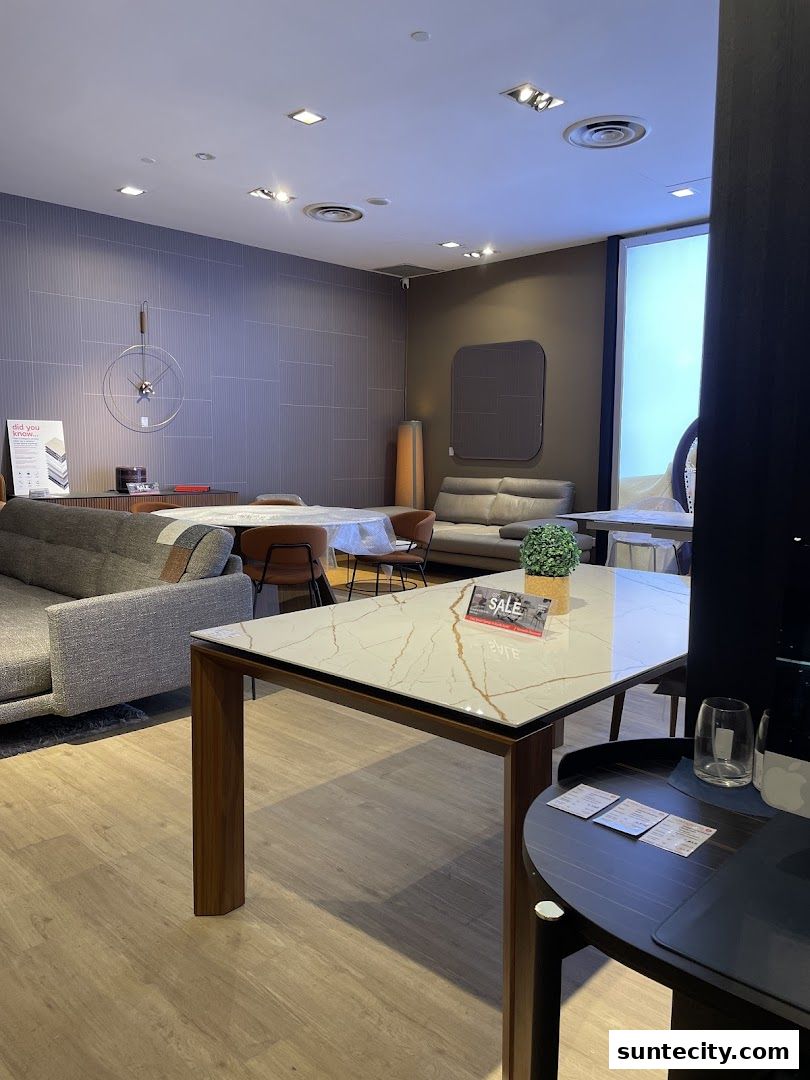 Interior of a luxury Italian furniture store showcasing sofas, dining tables, and decor.