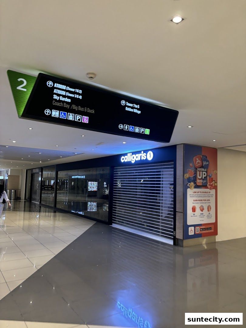 The Calligaris store with its shutters down, located in a mall hallway with directional signage.