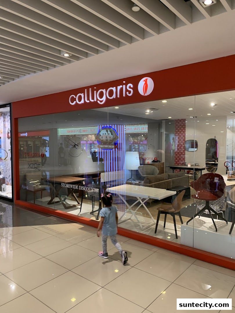 A child walks past a Calligaris furniture store with a display of Italian furniture.