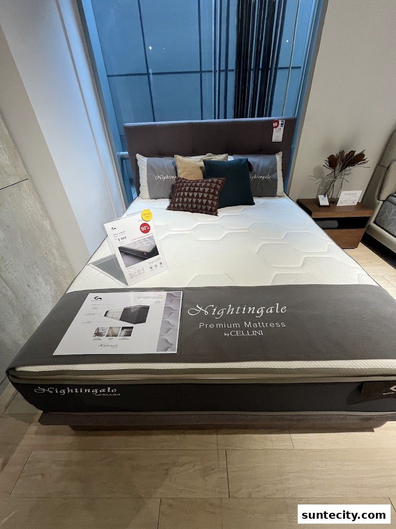 A premium Nightingale mattress by Cellini is displayed with decorative pillows and a bedside table.