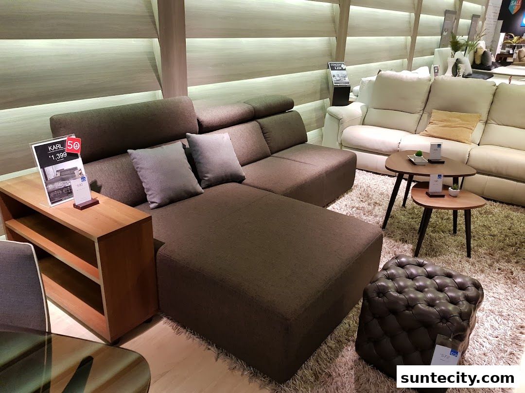 A modern living room display featuring a sectional sofa, accent chairs, and coffee tables.