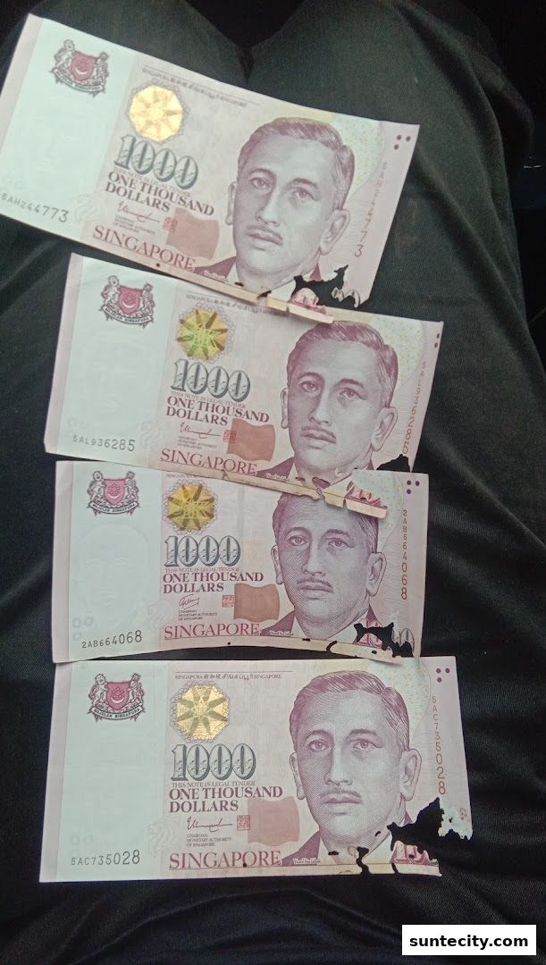 Four Singapore $1000 dollar banknotes are displayed, showing the portrait of Yusof Ishak.