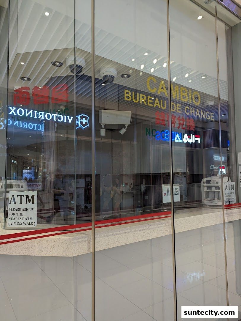 The exterior of a currency exchange shop with 'CAMBIO BUREAU DE CHANGE' signage and an ATM.