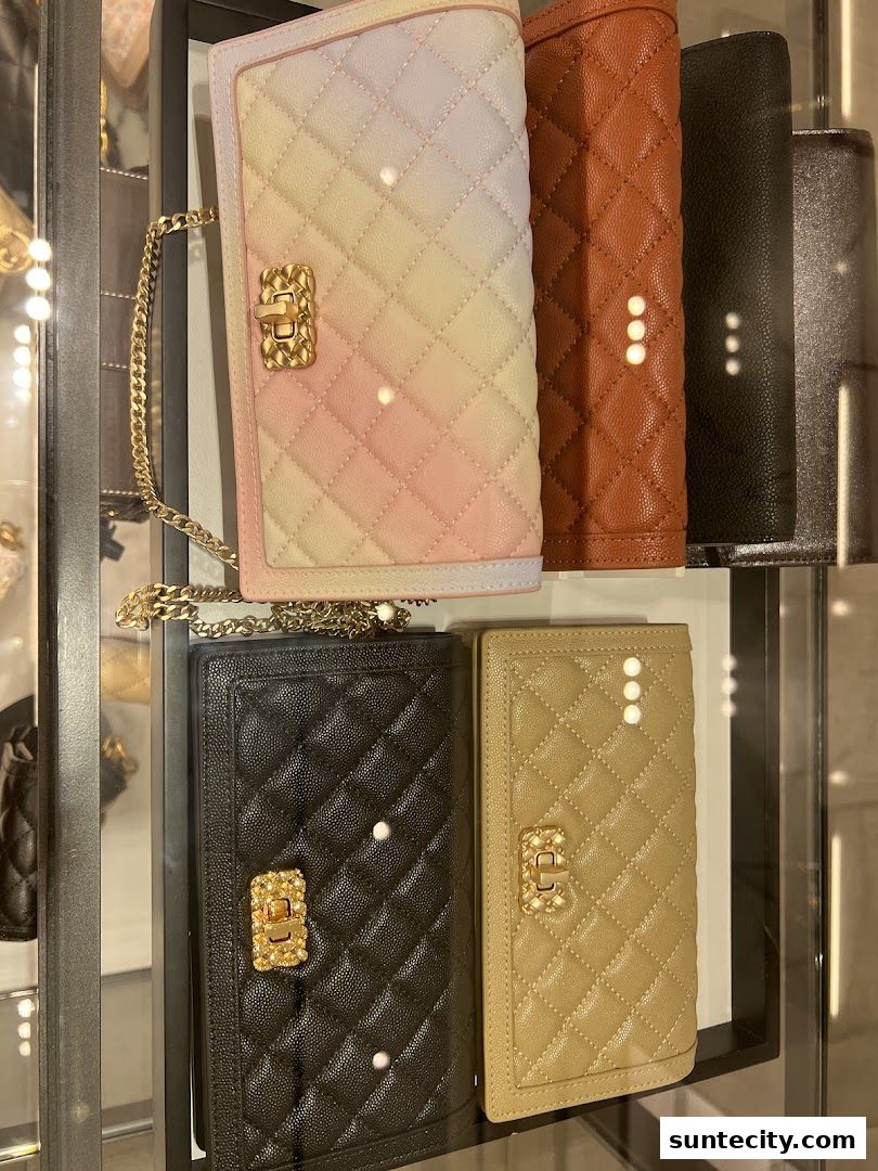 A display of quilted leather wallets and clutches in various colors and styles.
