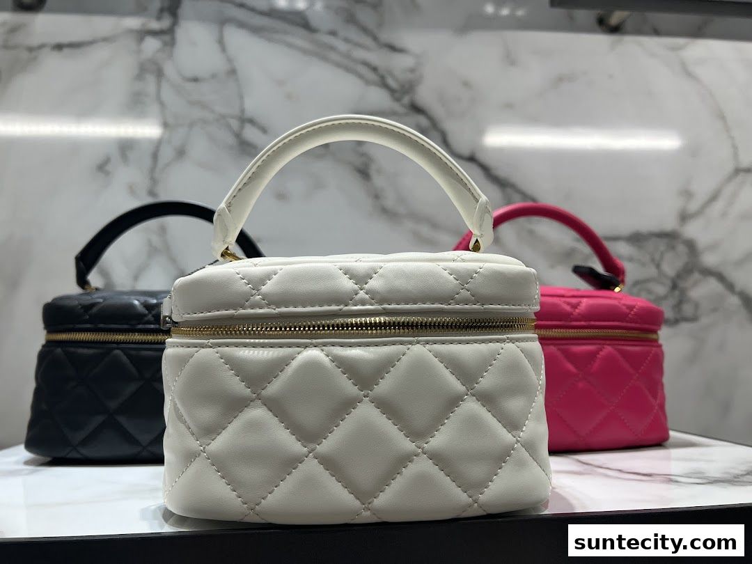 Three quilted vanity bags in white, black, and pink are displayed.