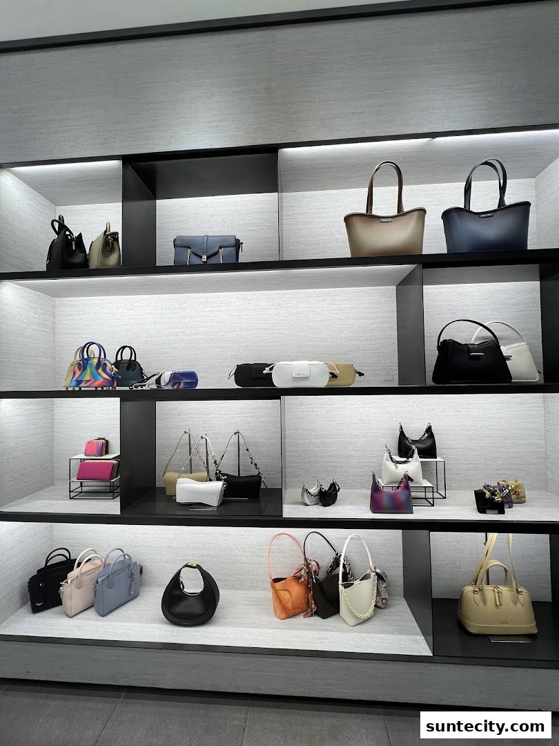 A display of various Charles & Keith handbags on shelves, showcasing different styles and colors.