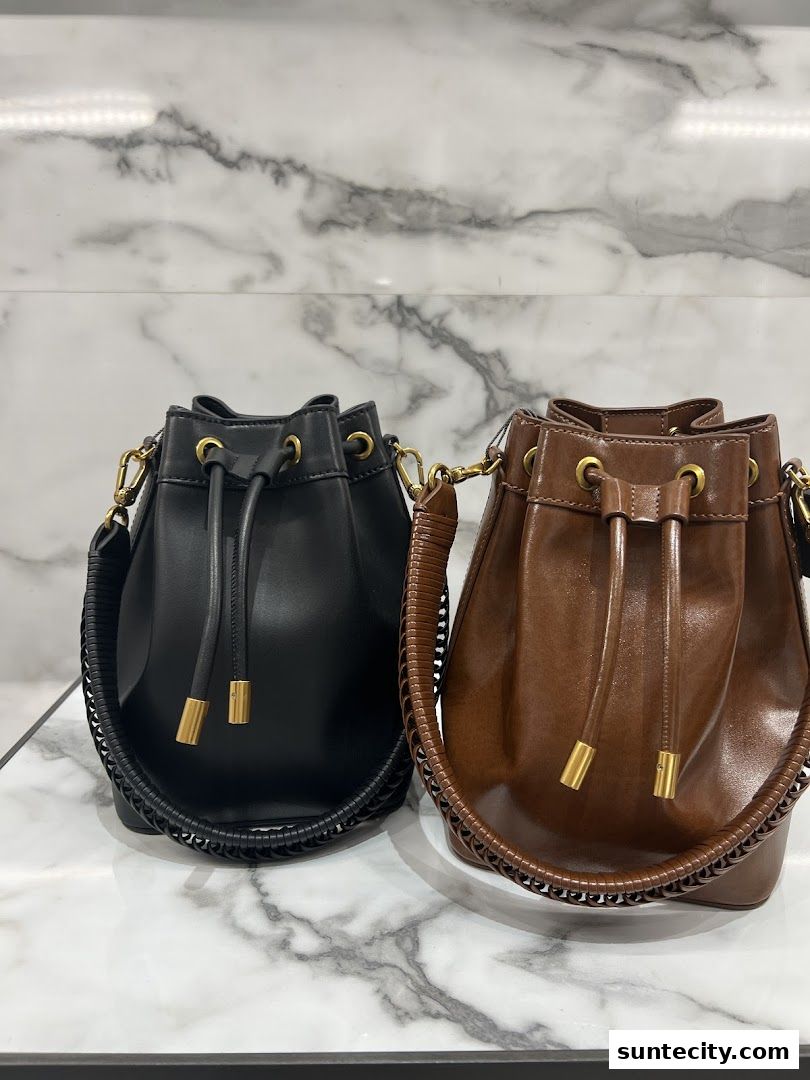 Two stylish bucket bags, one black and one brown, displayed against a marble background.