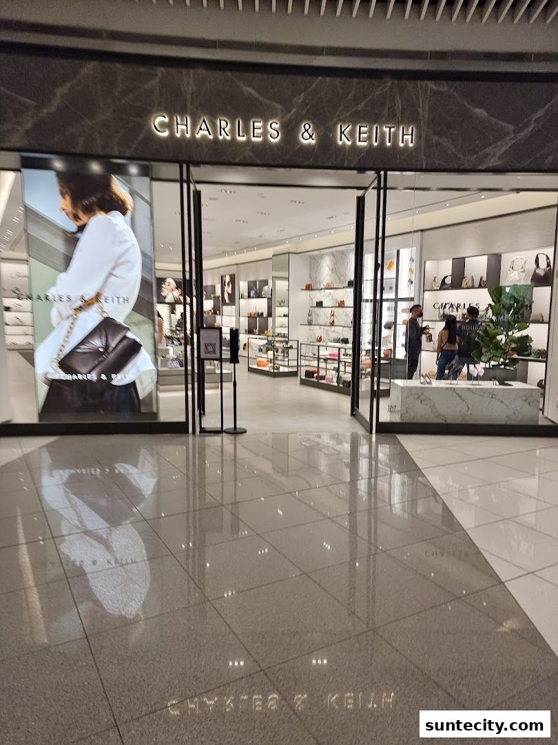 The entrance of a Charles & Keith store, showcasing handbags and shoes on display.