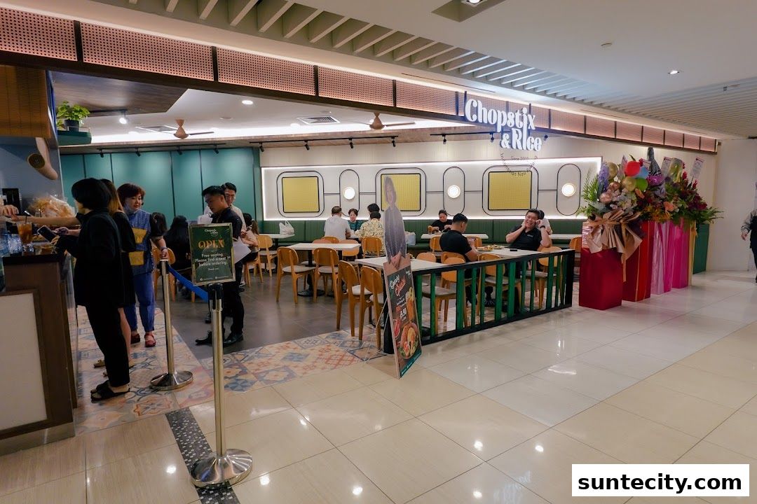 Interior view of Chopstix & Rice Indonesian Restaurant with customers dining and a queue forming.