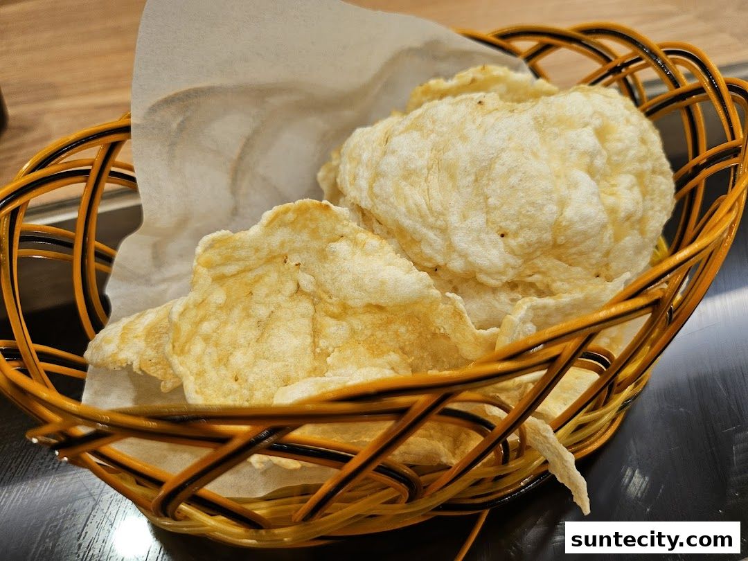 A close-up shot of crispy crackers served in a woven basket lined with white paper.