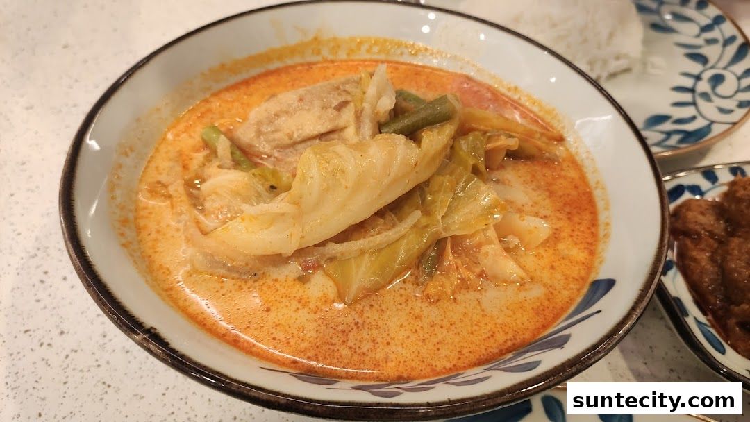 A close-up of a delicious Indonesian curry with vegetables and meat, served in a bowl.
