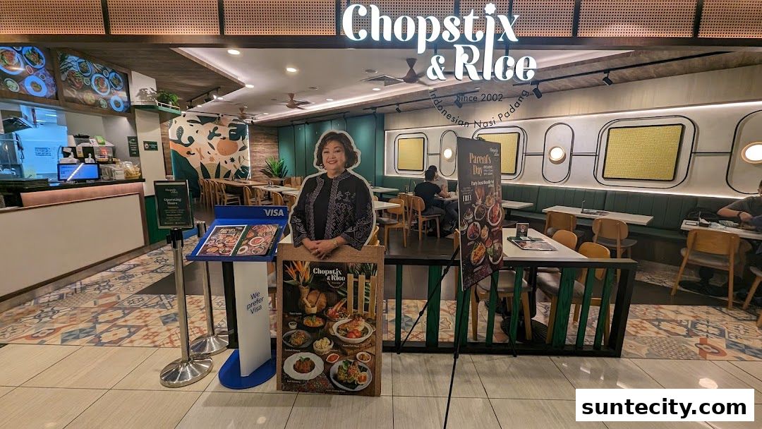 The entrance of Chopstix & Rice Indonesian Restaurant with a promotional display and seating area.