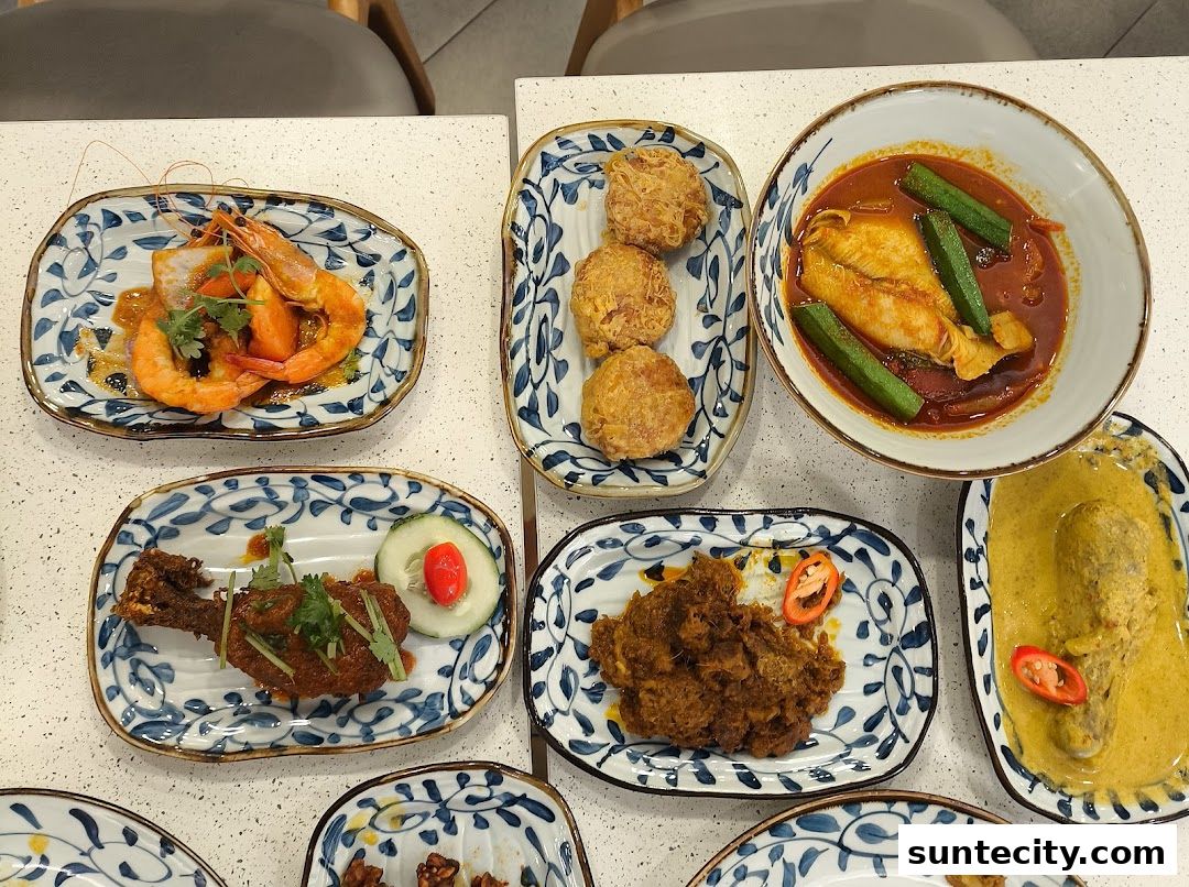 A spread of delicious Indonesian Padang cuisine, featuring prawns, fish curry, rendang, and fried chicken.
