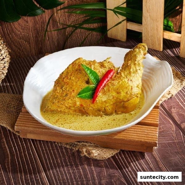 A close-up of a delicious Indonesian chicken dish in a white bowl, garnished with chili and leaves.