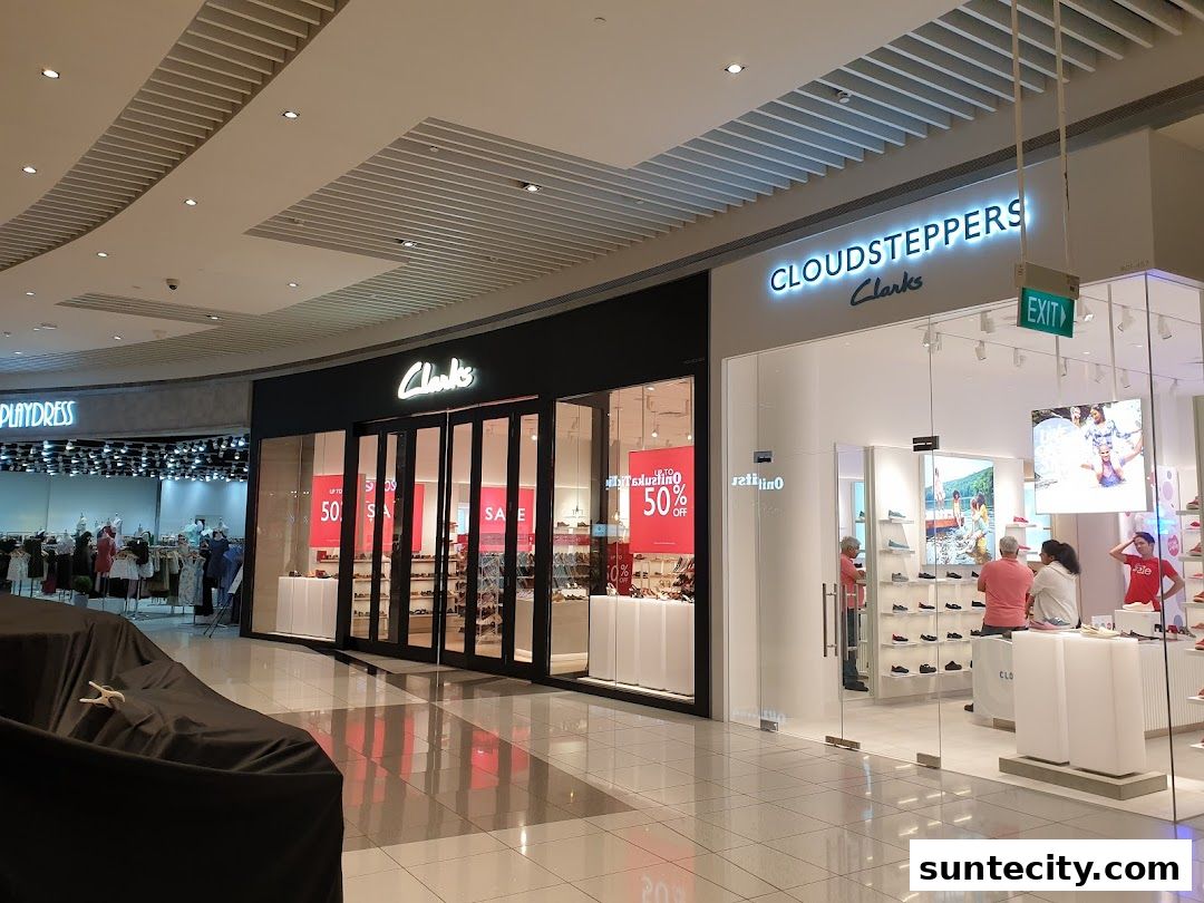 The exterior of a Clarks shoe store with a "Cloudsteppers" section and a sale sign.