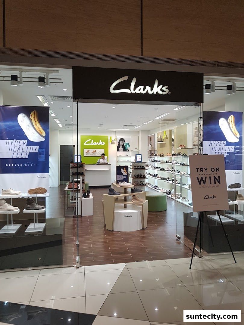 The exterior of a Clarks shoe store, showcasing various footwear and promotional displays.