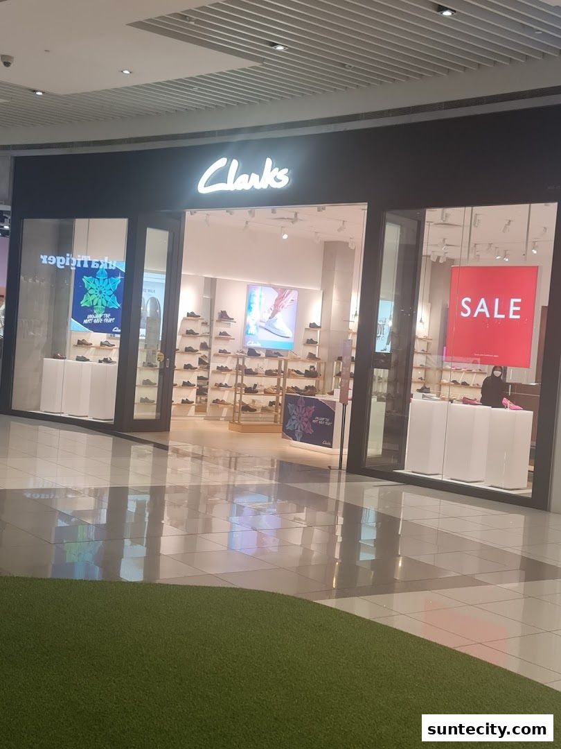 The exterior of a Clarks shoe store with a prominent 'SALE' sign in the window.