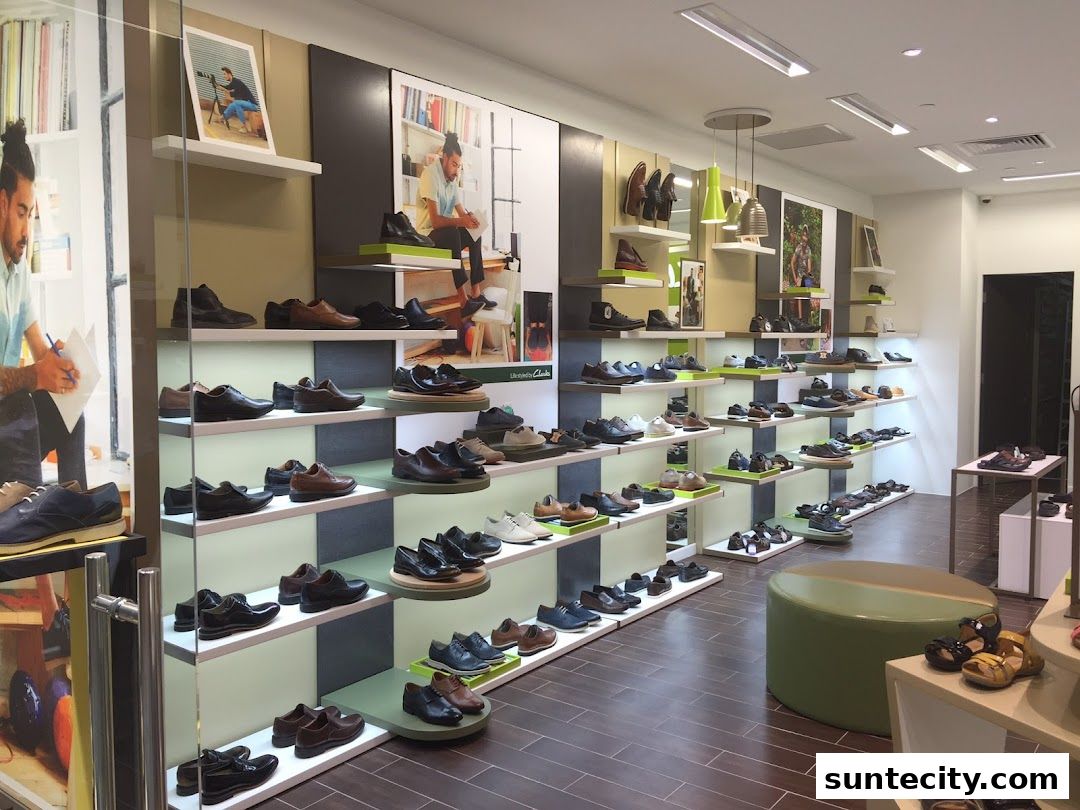 Interior view of a Clarks shoe store showcasing a wide variety of men's and women's footwear on display shelves.