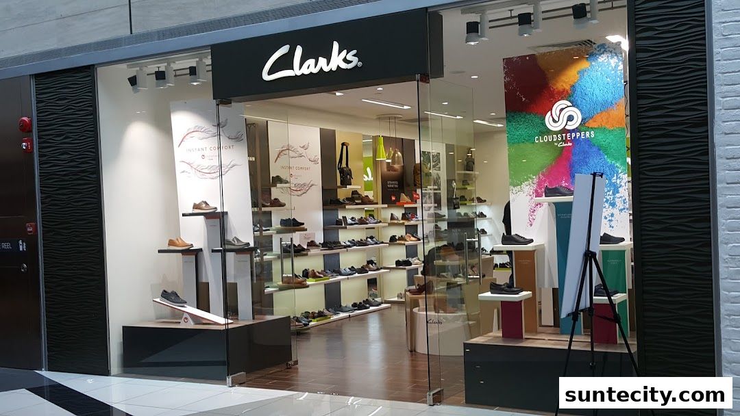 The exterior of a Clarks shoe store, showcasing various footwear on display.