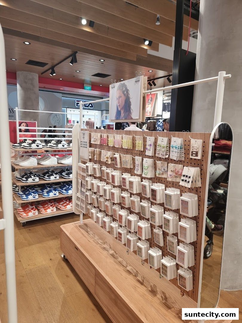 Interior view of a Cotton On store showcasing shelves of sneakers and a display of small accessories.