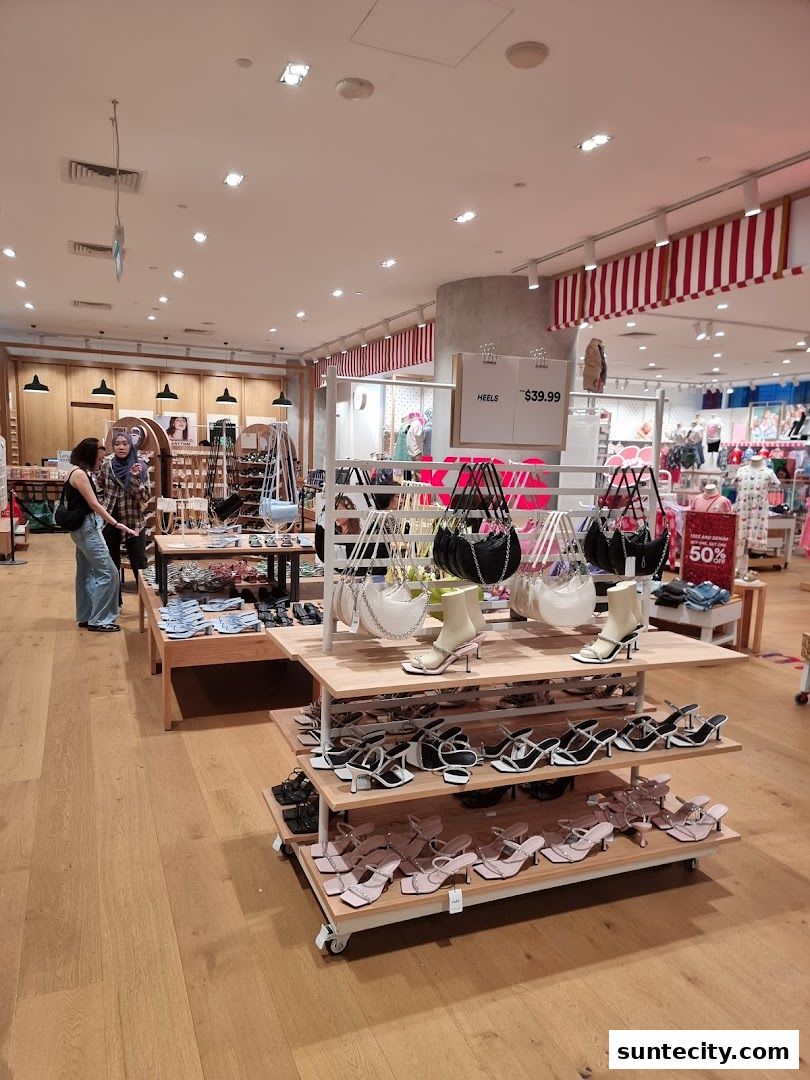 Interior view of a Cotton On store showcasing a variety of heels and handbags on display.