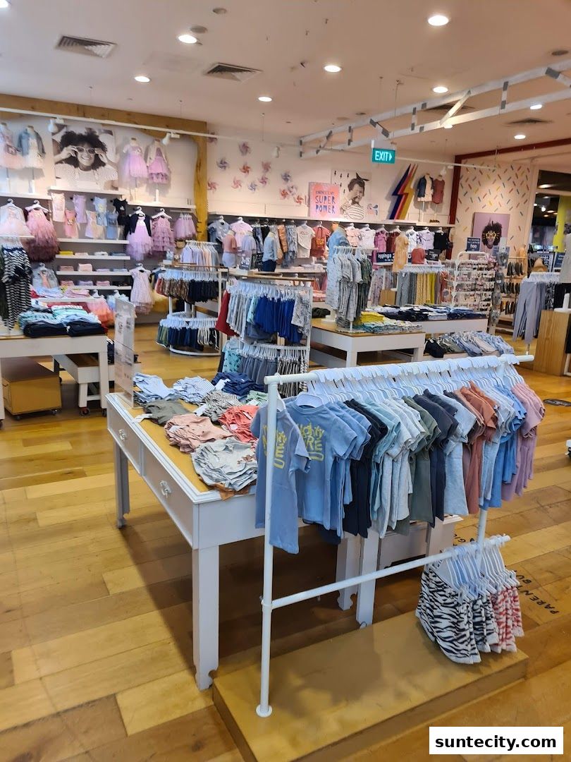 Interior view of a Cotton On store showcasing a wide selection of children's clothing on display racks and shelves.