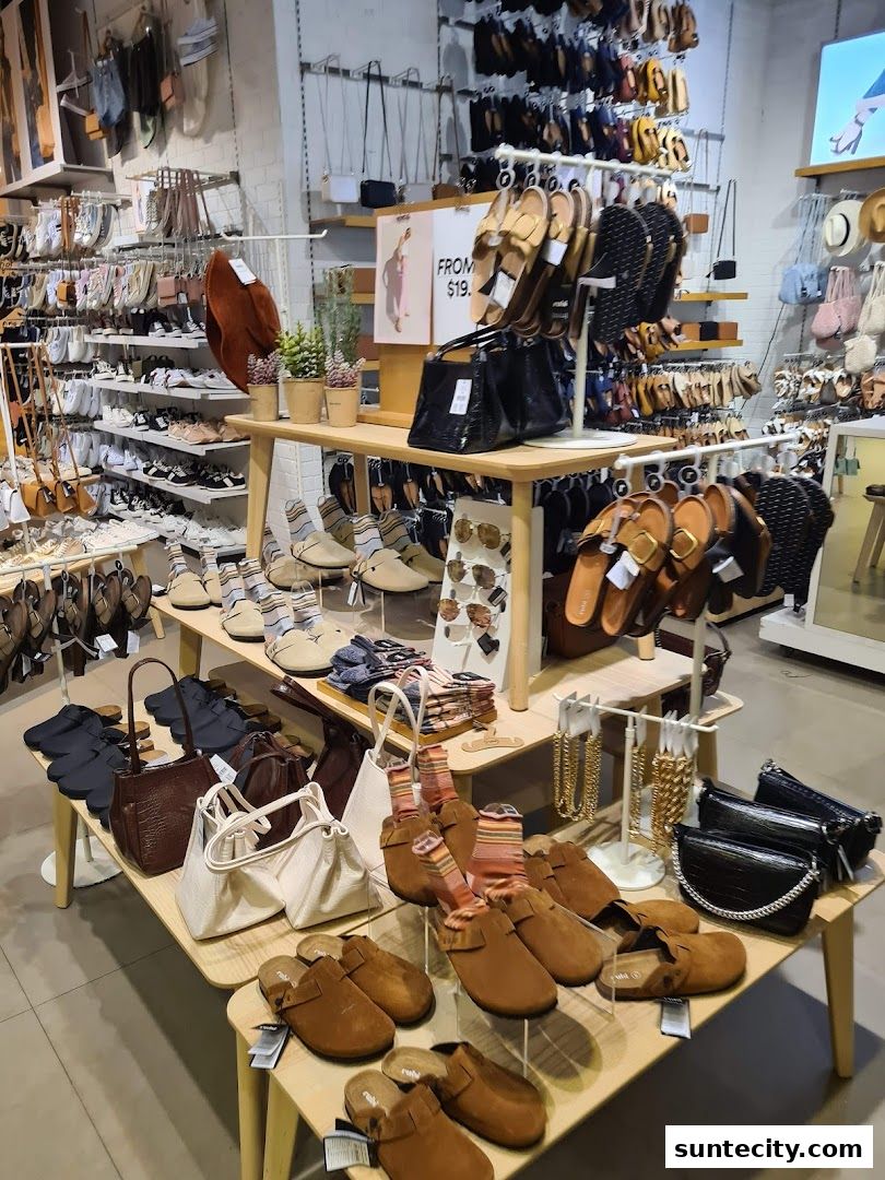Interior view of a Cotton On store showcasing a variety of footwear, handbags, and accessories.