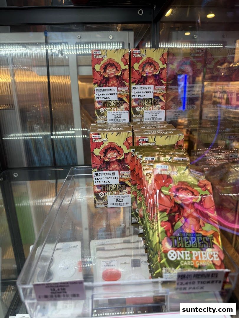 Packs of One Piece Card Game 'The Best' booster packs are displayed in a retail cabinet.