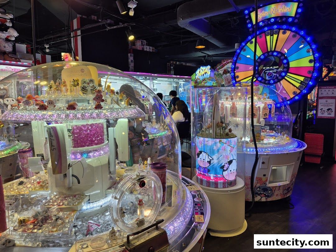 Brightly lit arcade with claw machines and a 'Spin-N-Win' game.