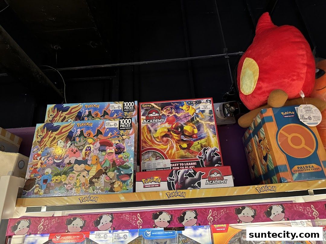 Pokemon themed puzzles and merchandise displayed on shelves, including a large plush toy.