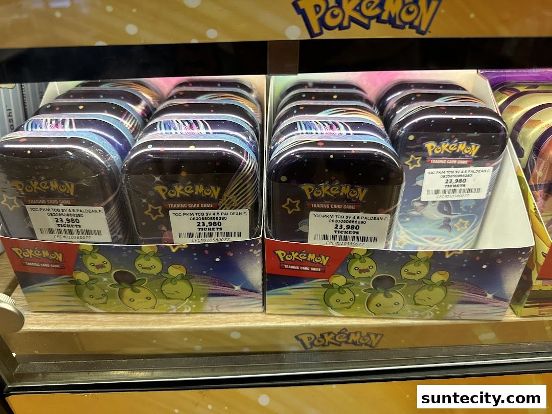 Rows of sealed Pokemon trading card game tins are displayed for sale.