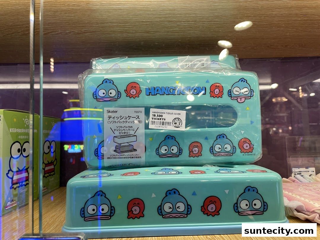 Cute blue tissue box covers featuring cartoon characters are displayed on shelves.