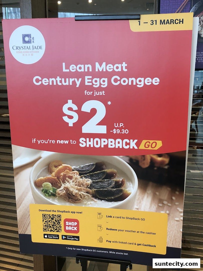 A promotional sign for Crystal Jade Hong Kong Kitchen offering Lean Meat Century Egg Congee for $2.