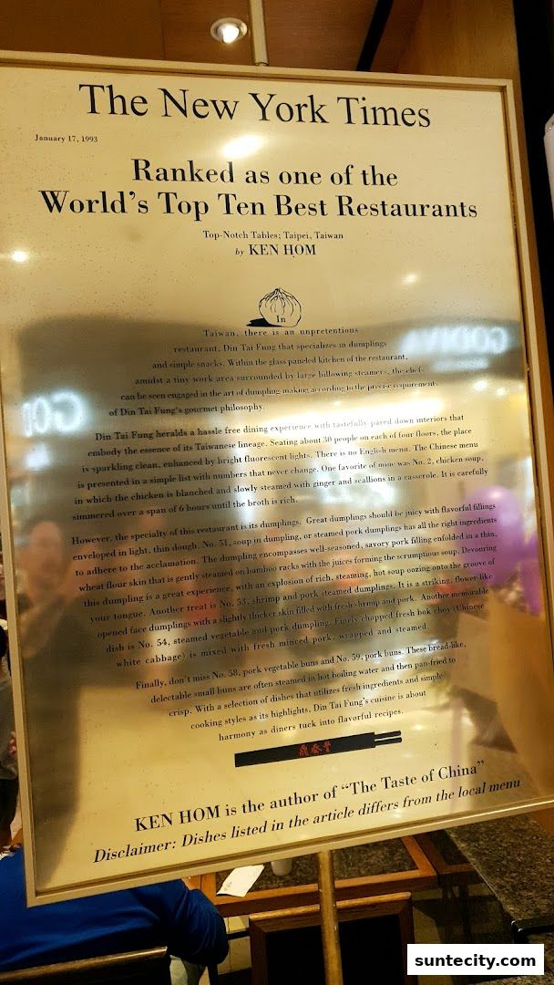 A framed article from The New York Times about Din Tai Fung, highlighting its dumplings.