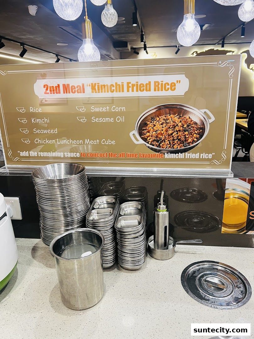 A sign advertising "Kimchi Fried Rice" with ingredients and a picture of the dish.