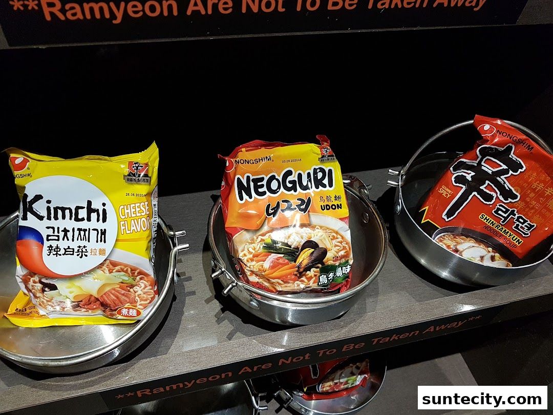 Three different flavors of instant Korean ramyeon noodles are displayed in metal bowls.