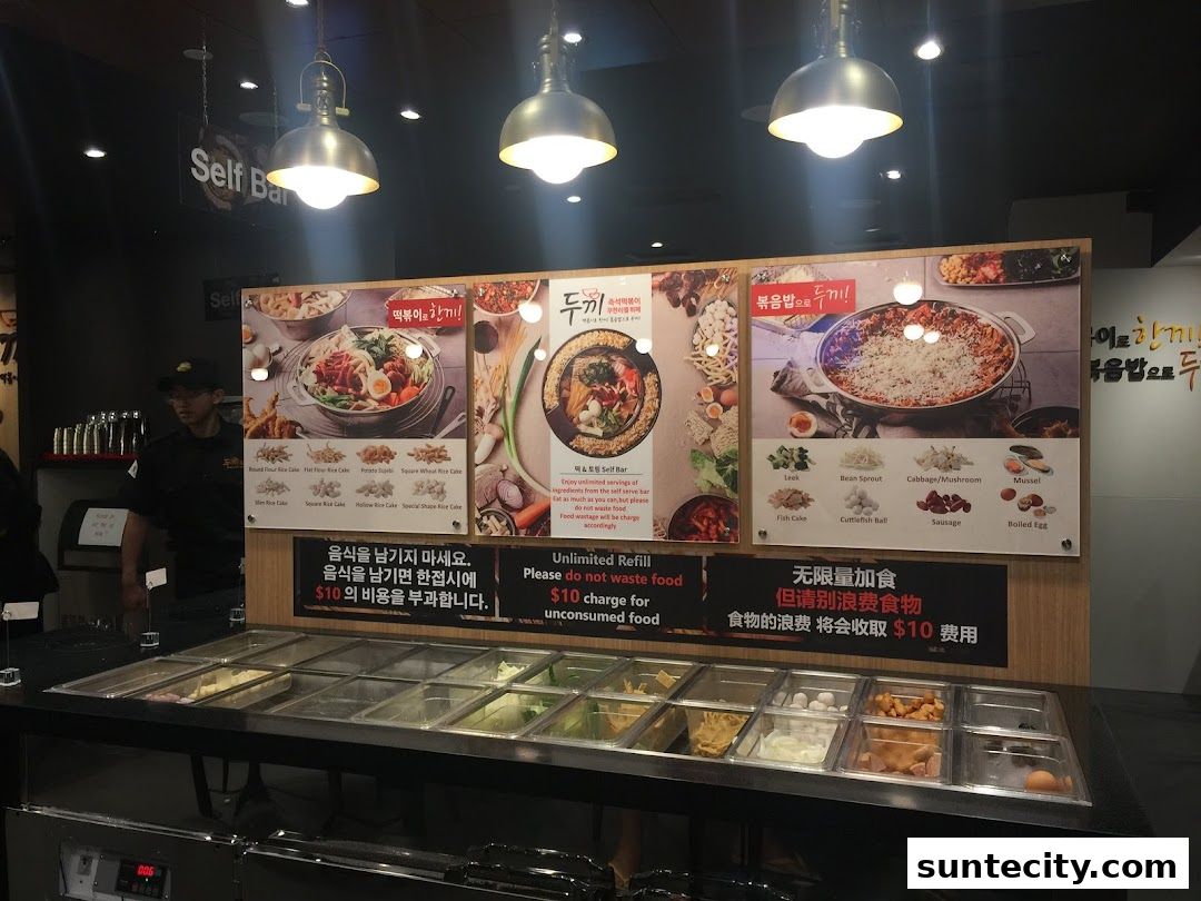 A self-serve bar with various food ingredients and promotional posters for Dookki.