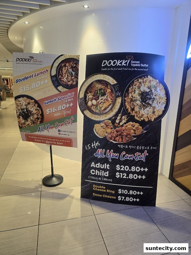 Two promotional signs for Dookki Korean Topokki Buffet, showcasing lunch specials and all-you-can-eat options.