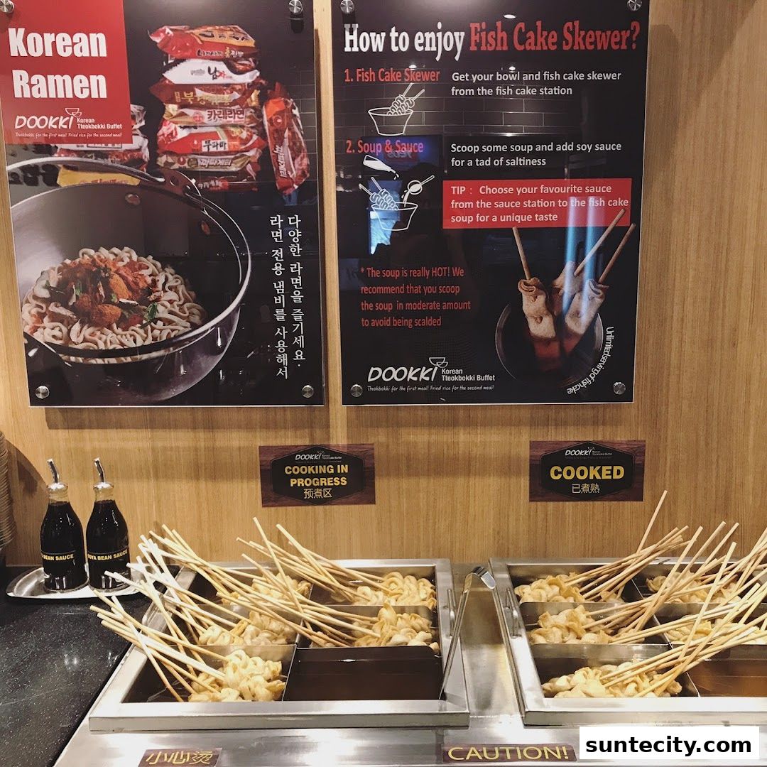 A display of Korean ramen and fish cake skewers at a restaurant.