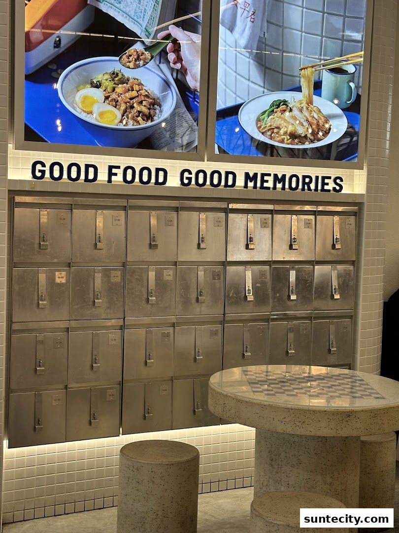 A wall of metal lockers with food images and seating area.