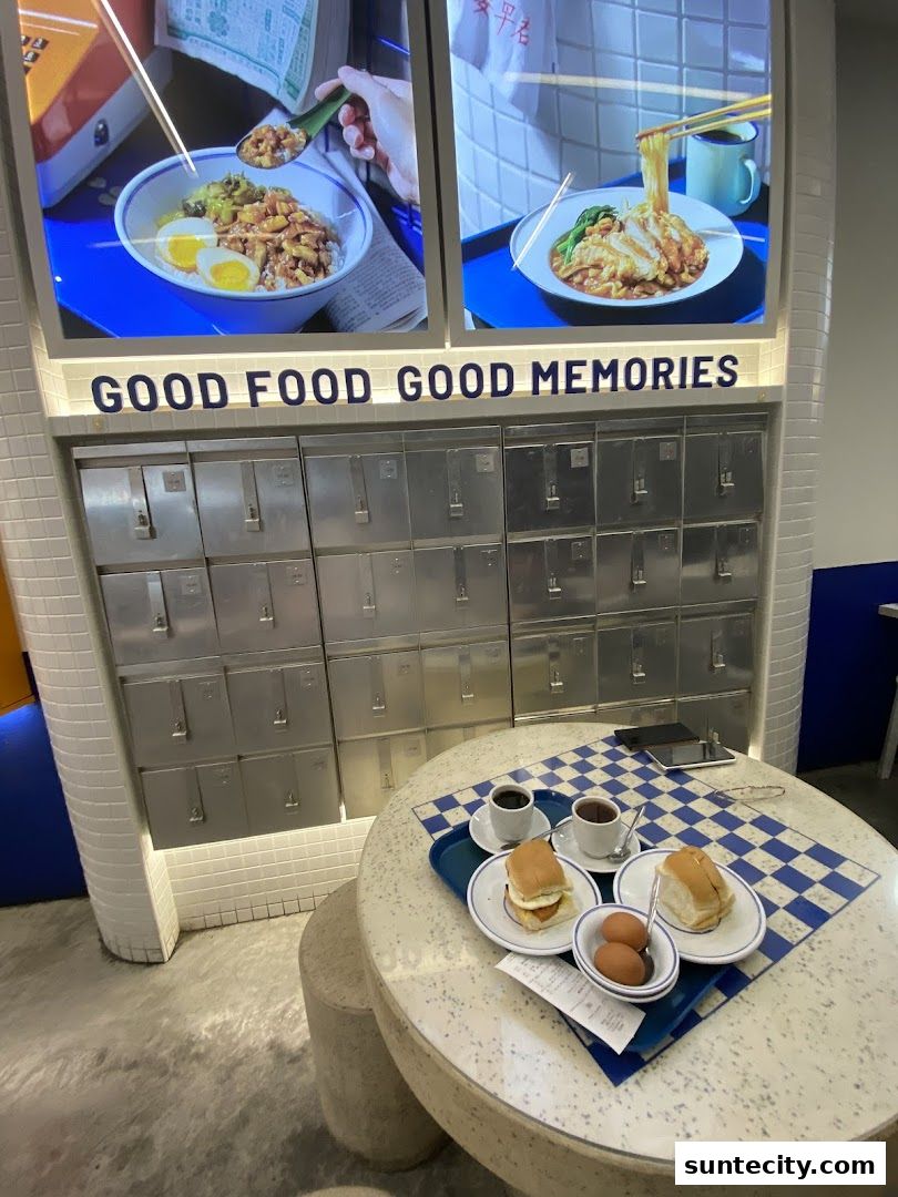 A table with breakfast items and a wall display with food images and lockers.