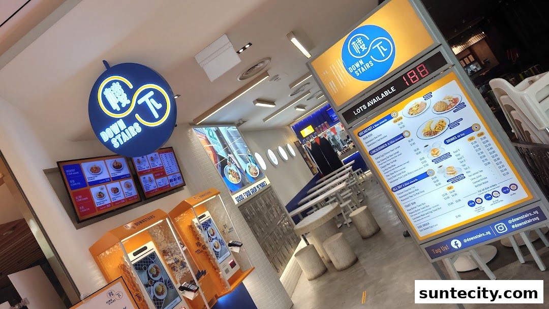 Interior view of a modern food stall with digital menus and seating.