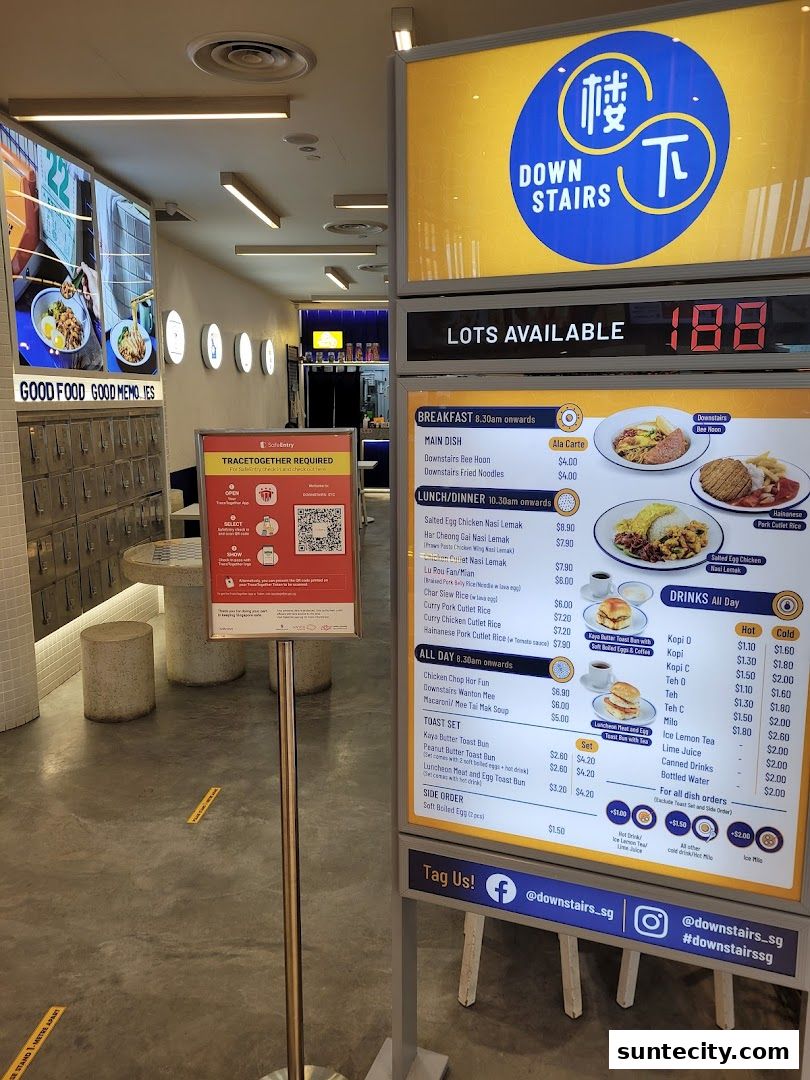A menu board for Downstairs restaurant in Suntec City, showcasing various dishes and drinks.