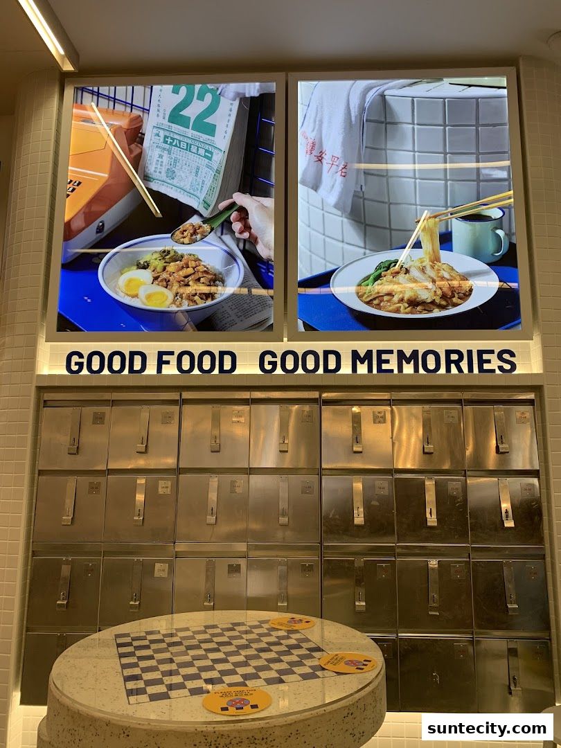 A shop interior featuring illuminated food images and a wall of metal lockers.