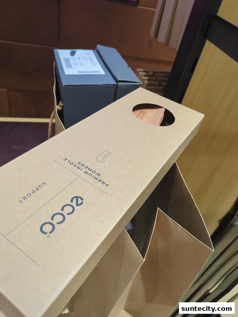 ECCO branded shoe boxes and packaging are displayed in a retail setting.