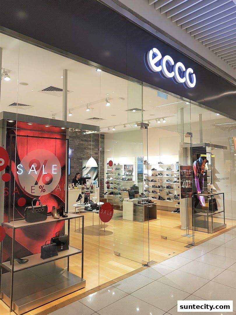 The ECCO store at Suntec City Mall features a modern storefront with a large glass display showcasing shoes and bags.