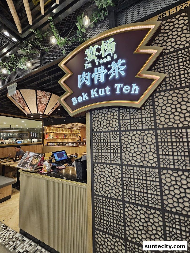 The entrance of En Yeohs Bak Kut Teh restaurant with its illuminated sign and interior visible.