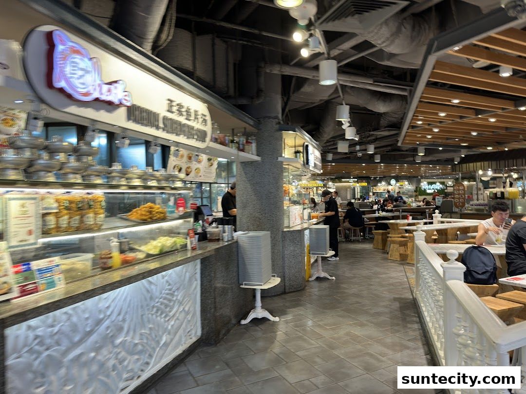 A bustling food court with various food stalls and seating areas, including a prominent stall named Food Republic.