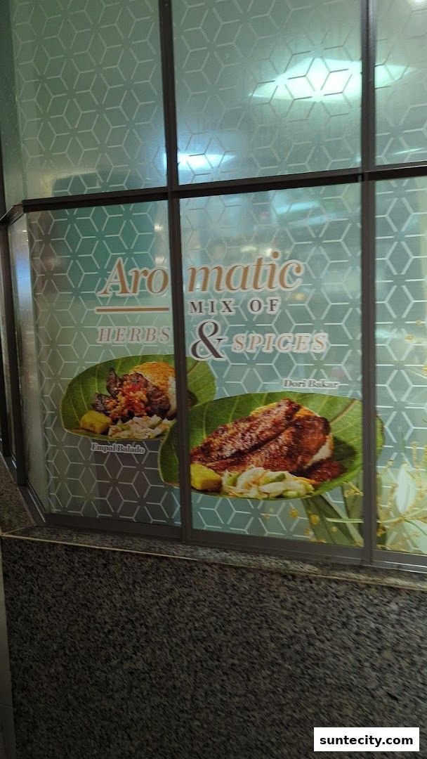 Window display for Food Republic featuring aromatic herbs and spices with two dishes.